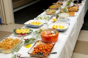 table filled with potluck dishes