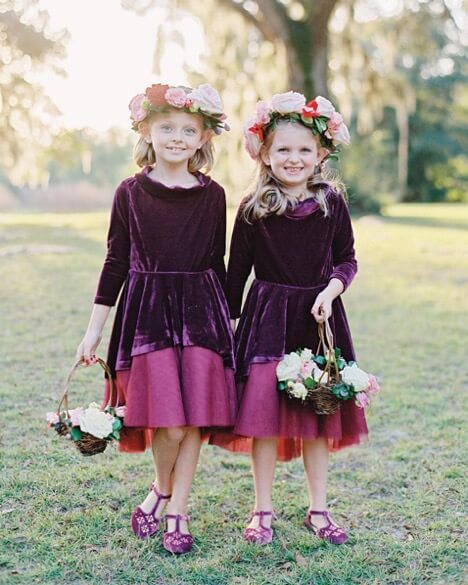 Young flower girls in velvet dresses